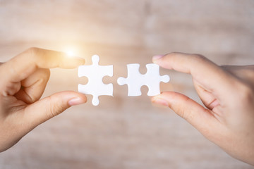 Businessman hand connecting couple puzzle piece. Business solutions, mission target, successful, goals, cooperation, partnership and strategy concept