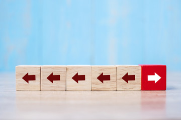 Red block with different direction of arrow on table background. Business Growth, Improvement, strategy, Successful, different and Unique Concepts