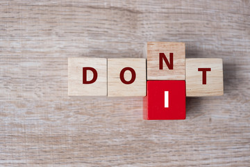 wooden cube with flip block DON T to DO IT word on table background. success, strategy, solution, business and Positive thinking concepts