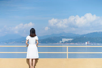 young asian woman looking at sea
