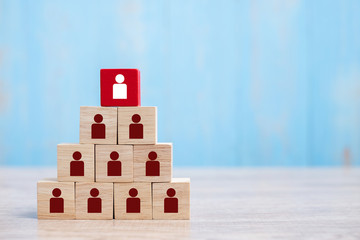Red wooden block with white person icon on the building. People, Business, Human resource management, Recruitment, Teamwork, strategy and leadership Concepts