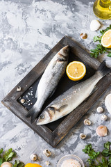Fresh branzino fish with parsley, lemon and pink Himalayan salt