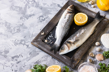 Fresh branzino fish with parsley, lemon and pink Himalayan salt