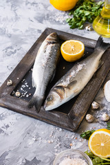 Fresh branzino fish with parsley, lemon and pink Himalayan salt