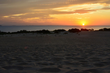 Sunset over the sound as seen from the top of the sand dunes in Jockeys Ridge State Park on the...