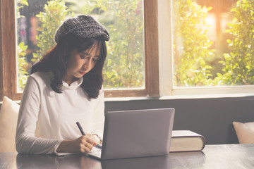 Asia woman using  laptop computer  working,playing with fun and happy.