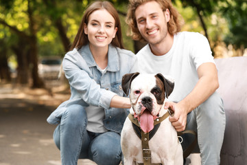 Young couple with cute dog in park