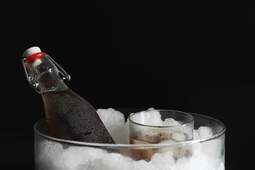 Fresh cola with ice on dark background