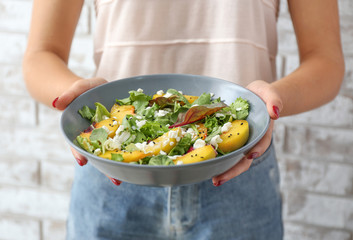 Woman with tasty salad in bowl, closeup