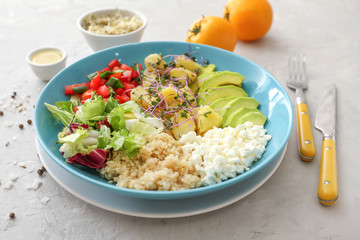 Plate with tasty salad on grunge background