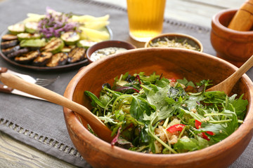 Bowl with tasty salad on table