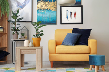 Stylish interior of living room with yellow armchair