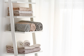 Obraz na płótnie Canvas Clean towels on rack in room