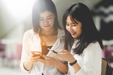 Asia women using smartphone working playing with fun and happy in free time.
