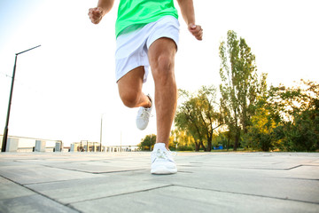 Handsome sporty man running outdoors