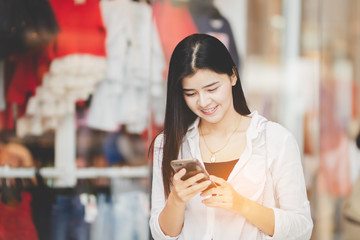 Asia woman using smartphone working playing with fun and happy in free time.
