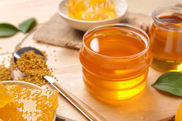 Jar of sweet honey on table