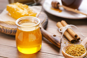 Jar of sweet honey on table