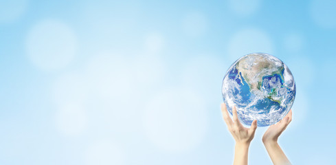 Ecology Concept : Hand holding blue planet earth globe with blurred bokeh background . (Elements of this image furnished by NASA.)