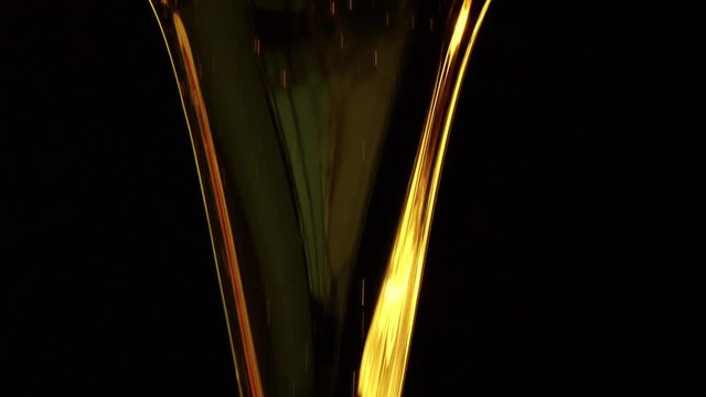 Motor oil pouring on black background. Slow motion