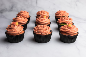 Chocolate halloween themed cupcakes, orange colored frosting, green and purple cupcake dough - 289956809