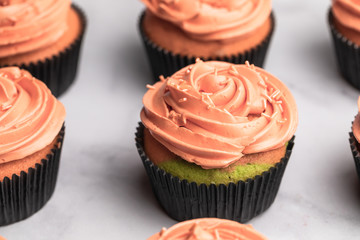 Chocolate halloween themed cupcakes, orange colored frosting, green and purple cupcake dough - 289957014