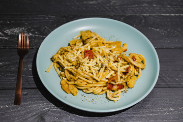 bucatini pasta with tomatoes and veggies and vegan cheese