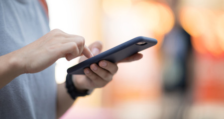 People use smartphone on evening street