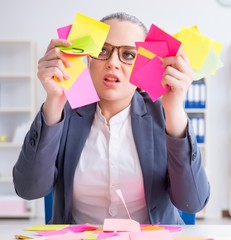 Businesswoman with conflicting priorities in office