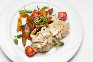 mushrooms in sauce with potatoes and a vegetables