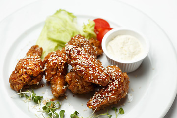 deep fried chicken wings with vegetables and a sauce