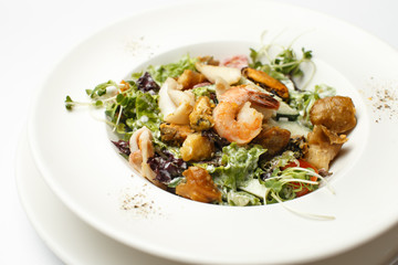 seafood with vegetables in a white plate
