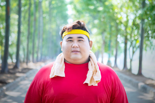 Young fat man wearing sportswear on the road