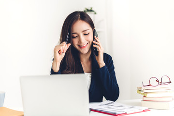 Businesswoman sitting and working with laptop computer.creative business people planning in her workstation at modern work loft