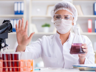 Female scientist researcher conducting an experiment in a labora