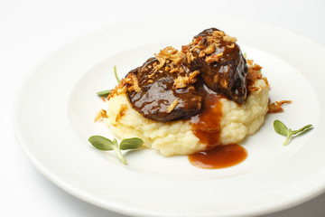 meat with potato puree on a white background
