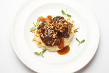 meat with potato puree on a white background
