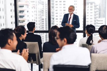 Businessman standing in front of group of people in consulting meeting conference seminar at hall or seminar room.presentation and coaching concept