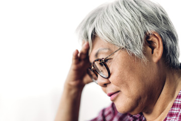 Senior adult elderly asia women serious depressed and feeling headache, thinking of problems on white background