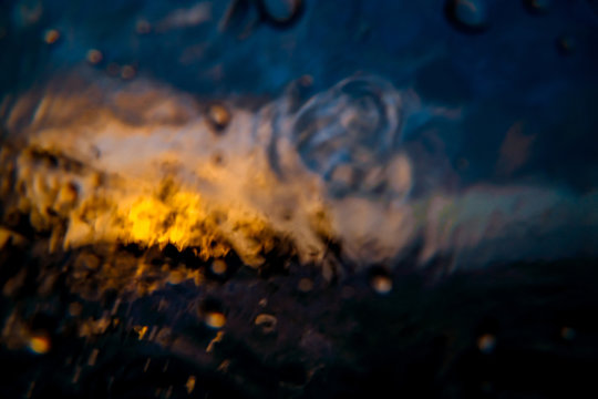 Abstract image of an orange sunset. Shot made through the wave.