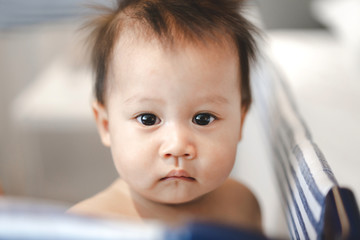 Portrait of happy smile baby relaxing on the bed