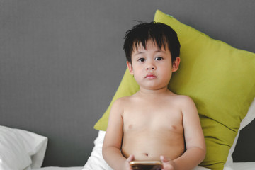 Portrait of Little baby boy on the bed at home