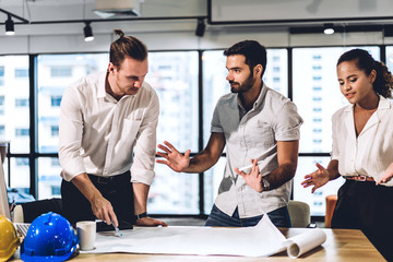 Team engineers working with construction tools on table