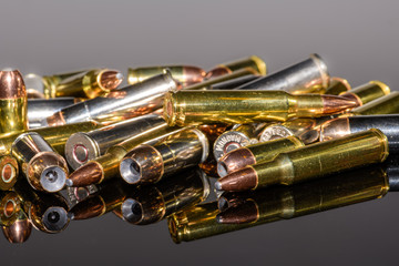 Naklejka premium Miscellaneous semi-automatic handgun and rifle ammunition on black background,