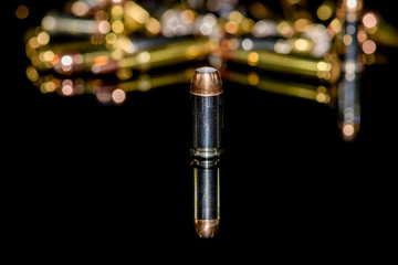 Naklejka premium 40 caliber semi-automatic handgun ammunition on black background, selective focus