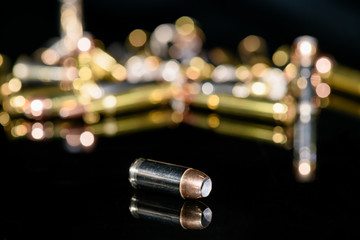 40 caliber semi-automatic handgun ammunition on black background, selective focus
