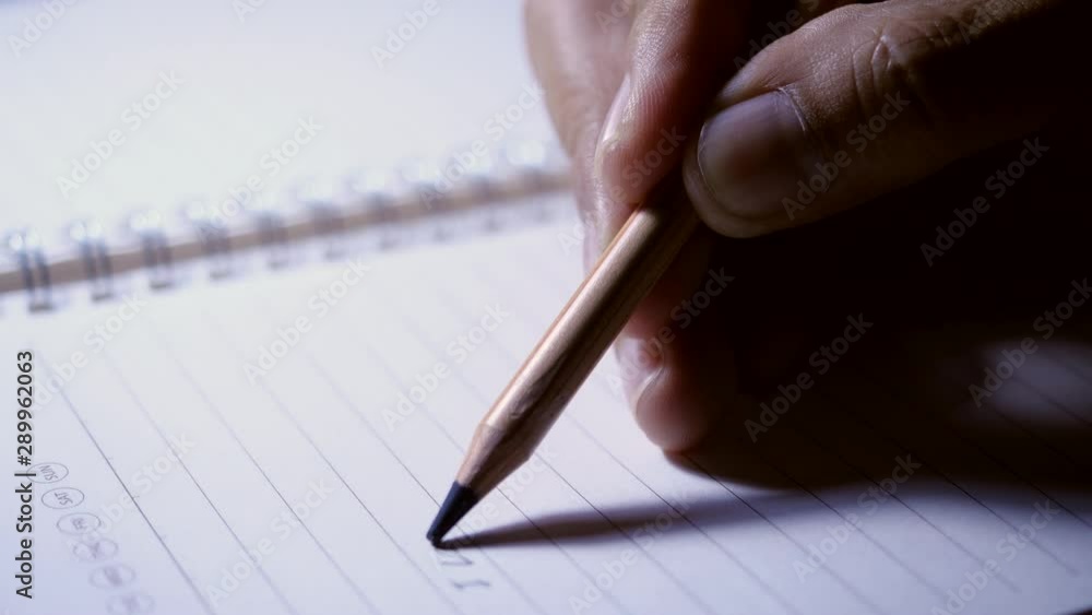 Poster close-up for hand pencil writing in a notebook