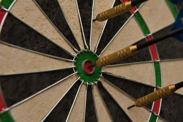 One of three darts hits the center of the darts board also known as 