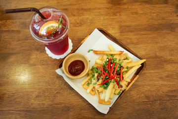 french fries and beverage on table