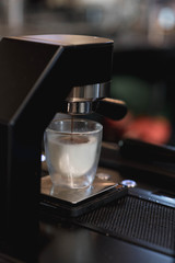 Barista making a espresso with a coffee machine.